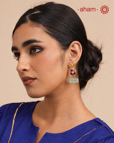 Elegant gold polish Earrings embellished. Handcrafted in 92.5 sterling silver with rani pink stone setting and aqua coloured semi precious stobe. Perfect for special occasions and festivities.