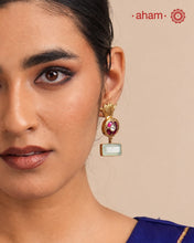 Elegant gold polish Earrings embellished. Handcrafted in 92.5 sterling silver with rani pink stone setting and aqua coloured semi precious stobe. Perfect for special occasions and festivities.