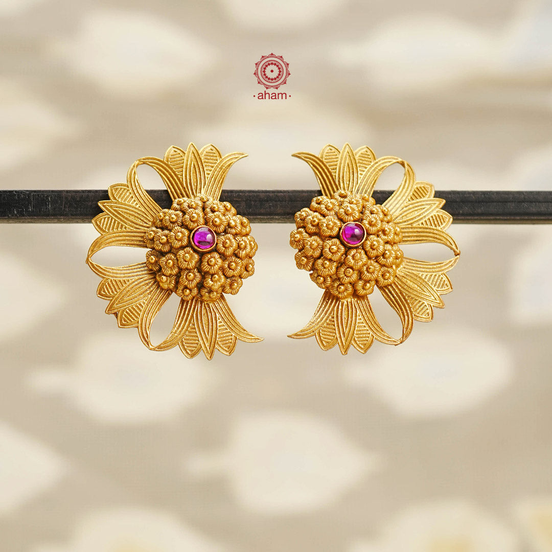 Crafted in 92.5 silver with a stunning gold polish, these Earrings feature a beautiful interpretation of the lotus flower. The intricate design showcases exceptional craftsmanship and adds a touch of elegance to any outfit. Elevate your style with these unique and timeless earrings.