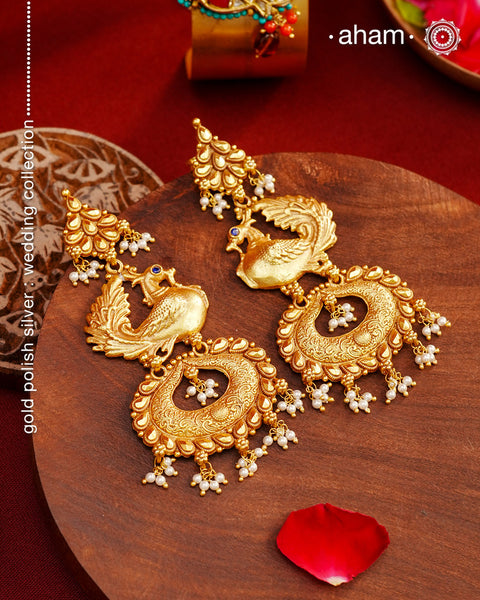 Perfect peacock earrings crafted in 92.5 silver with dull gold polish and laced with tiny pearls. Long, light weight and easy to wear all day long.