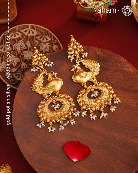 Perfect peacock earrings crafted in 92.5 silver with dull gold polish and laced with tiny pearls. Long, light weight and easy to wear all day long.