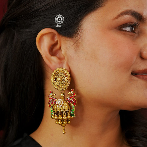 Elevate your style with our Peacock Gold Polish Silver Jhumkas. Crafted with stunning kundan peacocks, these statement earrings are the perfect accessory to elevate any outfit. The gold polish adds a touch of elegance, making them a versatile match for most ensembles..