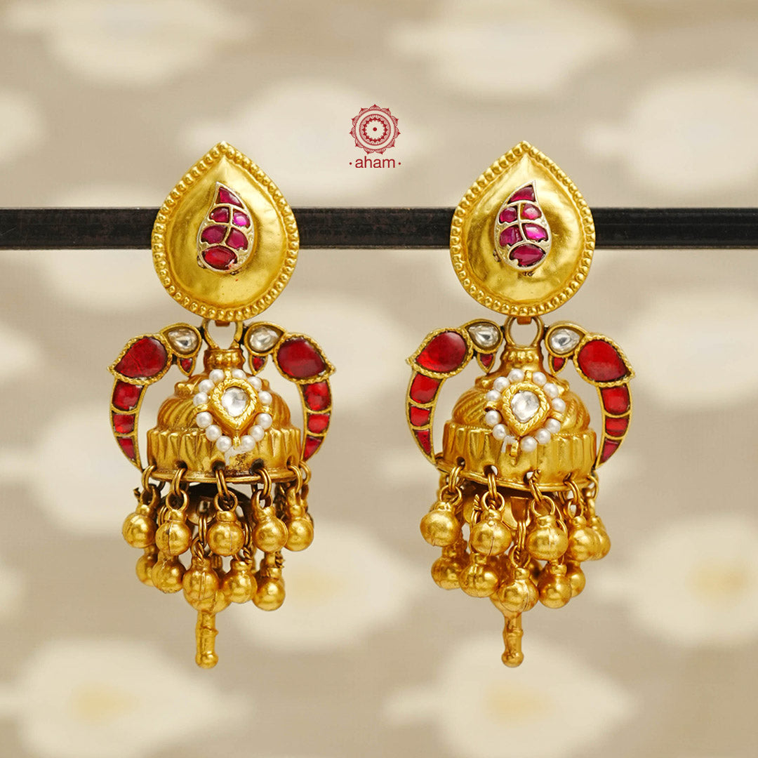 Elevate your style with our Parrot Gold Polish Silver Jhumkas. Crafted with stunning kundan parrots on both sides of the jhumkie, these statement earrings are the perfect accessory to elevate any outfit. The gold polish adds a touch of elegance, making them a versatile match for most Indian ensembles.