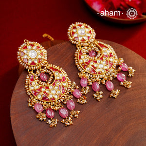 Crafted by master artisans in 92.5 silver, these Statement Chandbali Gold Polish Silver Earrings showcase magnificent Kundan work with stone drops fit for a queen. Perfect for grand celebrations, the intricate craftsmanship exudes regal elegance. Elevate any outfit with these stunning earrings.