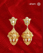 Step into the timeless elegance of our Mother of Pearl Gold Polish Silver Jhumkie. This Victorian-inspired chandelier design features lustrous gold polish and a stunning mother of pearl accent. Exquisitely crafted in silver, this is a must-have for any jewelry collection. Elevate your look with this exquisite piece.