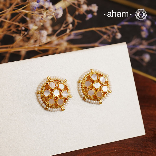 Embrace the allure of timeless elegance with Aham Jewellery’s latest Mother of Pearl collection, a radiant choice for festive celebrations and weddings. The earrings are crafted in 92.5 silver and adorned with a luxurious gold polish, capturing the iridescent beauty of mother of pearl.This collection is designed with festivities, bridesmaids, and destination weddings in mind, offering a versatile blend of tradition and contemporary charm. Ideal for those seeking an ethereal statement, our Mother of Pearl co