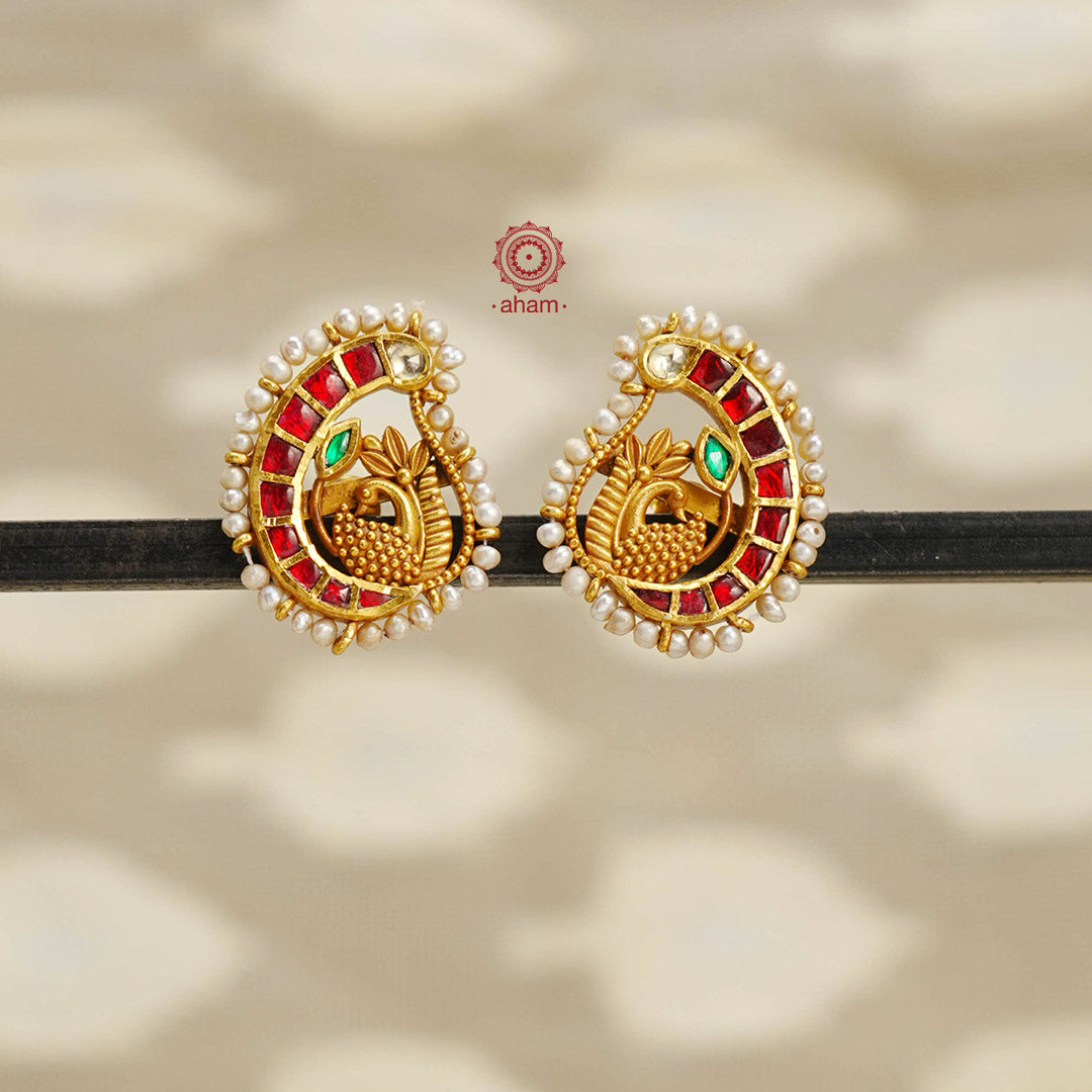 Elegant Peacock earrings embellished with fine kundan and pearls. Handcrafted in 92.5 sterling silver with gold polish. Perfect for special occasions and festivities.