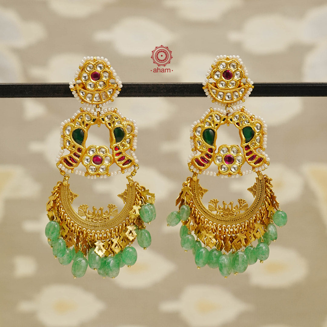 These Statement Chandbali Earrings showcase the finest of Indian workmanship, with delicate green beads and intricate kudan highlights. Its bold design makes a one-of-a-kind statement, perfect for any occasion. With its elegant gold polish and crafted in fine silver, these earrings are a must-have for any jewelry collection