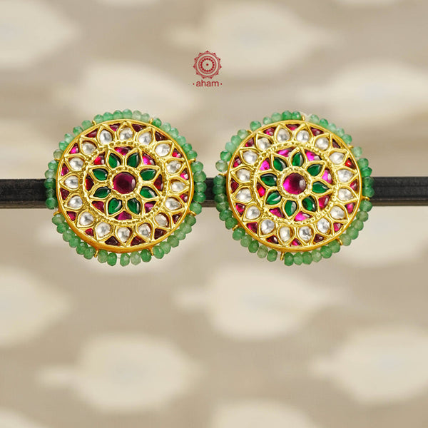Festive gold polish studs with vibrant floral work. Handcrafted in 92.5 sterling silver using jadau kundan techniques. Perfect for special occasions, pair these floral earrings with your favorite ethnic outfits.