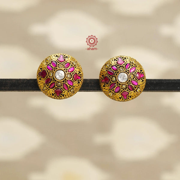 Crafted with 92.5 silver and delicate rani pink kundan work, these Gold Polish Silver Studs are the perfect versatile accessory. Expertly designed, they add a touch of elegance to any outfit. Upgrade your style now.