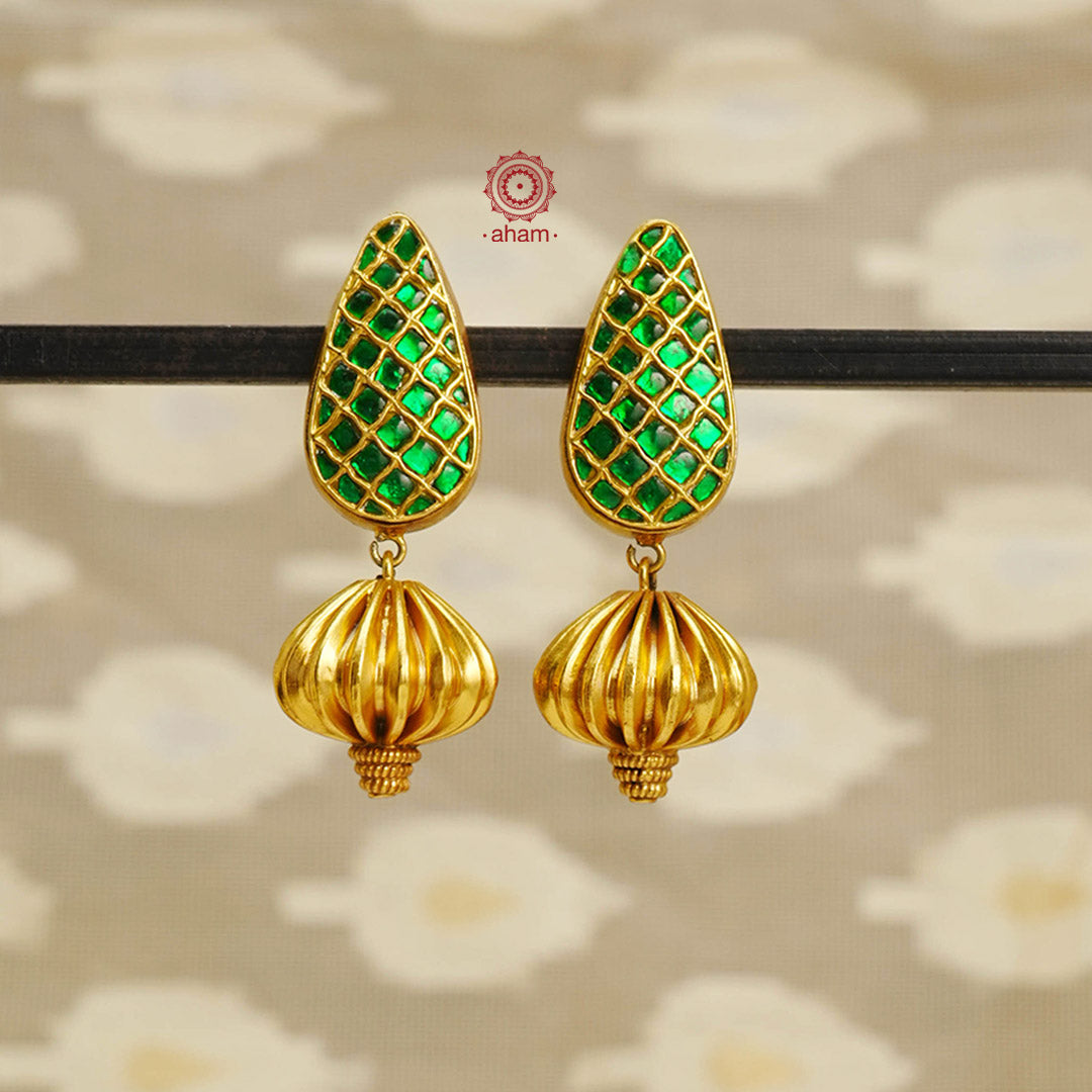 Expertly crafted with a blend of modern and traditional elements, our Gold Polish Silver Earrings feature stunning green kundan work. The perfect statement piece to elevate any outfit, these earrings add a touch of elegance and sophistication. Handmade with silver and finished with a lustrous gold polish, these one-of-a-kind earrings are sure to impress.