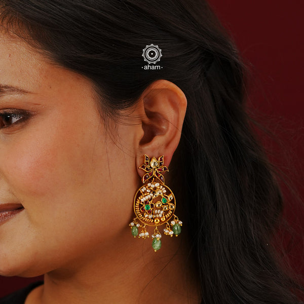 Indulge in elegance with these Gold Polish Silver Earrings. Made from 92.5 silver, expertly crafted with gold polish, and adorned with pearls and kundan work, these earrings showcase a traditional design. Elevate any outfit with the timeless beauty of these earrings.