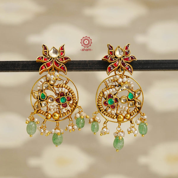 Indulge in elegance with these Gold Polish Silver Earrings. Made from 92.5 silver, expertly crafted with gold polish, and adorned with pearls and kundan work, these earrings showcase a traditional design. Elevate any outfit with the timeless beauty of these earrings.