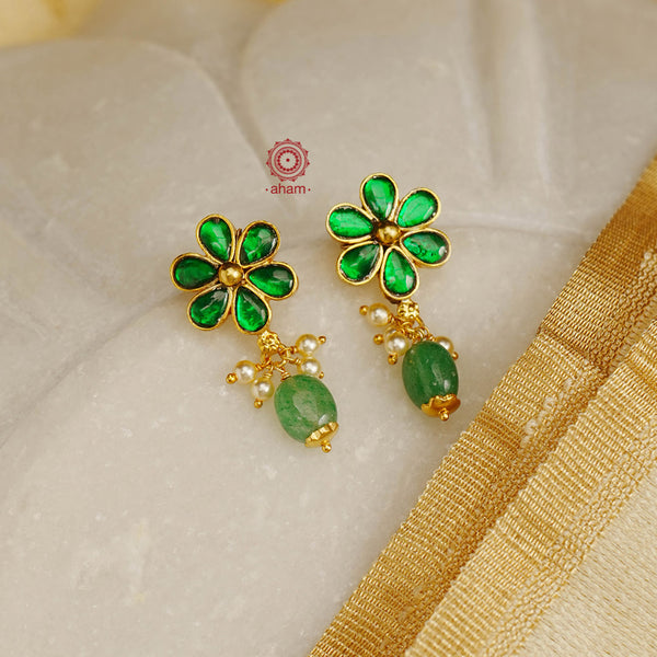 Elegant earrings embellished with green kundan. Handcrafted in 92.5 sterling silver and dipped in gold. Perfect for special occasions and festivities. 