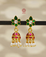 Elegant gold polish Earrings embellished with kundan and kemp work. Handcrafted in 92.5 sterling silver and dipped in gold polish. Perfect for special occasions and festivities.