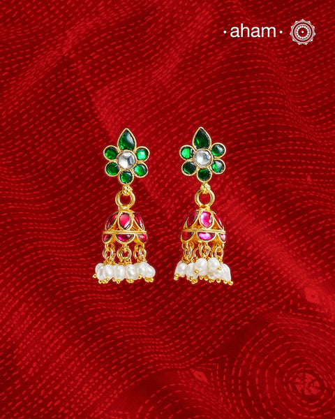 Elegant gold polish Earrings embellished with kundan and kemp work. Handcrafted in 92.5 sterling silver and dipped in gold polish. Perfect for special occasions and festivities.