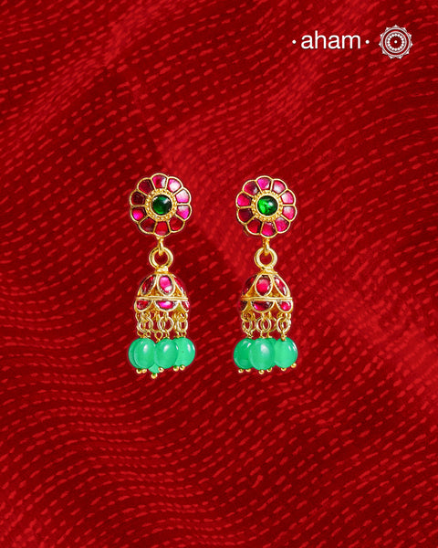 Elegant gold polish Earrings embellished with kundan and kemp work. Handcrafted in 92.5 sterling silver and dipped in gold polish. Perfect for special occasions and festivities.
