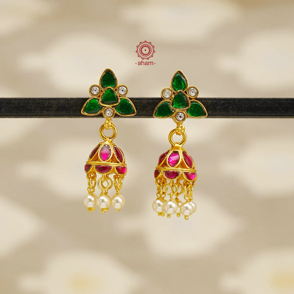 Elegant gold polish Earrings embellished with kundan and kemp work. Handcrafted in 92.5 sterling silver and dipped in gold polish. Perfect for special occasions and festivities.