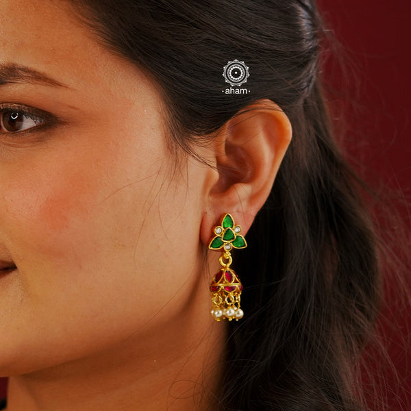 Elegant gold polish Earrings embellished with kundan and kemp work. Handcrafted in 92.5 sterling silver and dipped in gold polish. Perfect for special occasions and festivities.
