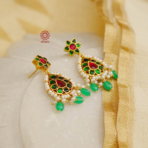 Elegant gold polish Earrings embellished with kundan and laced with pearls. Handcrafted in 92.5 sterling silver. Perfect for special occasions and festivities.