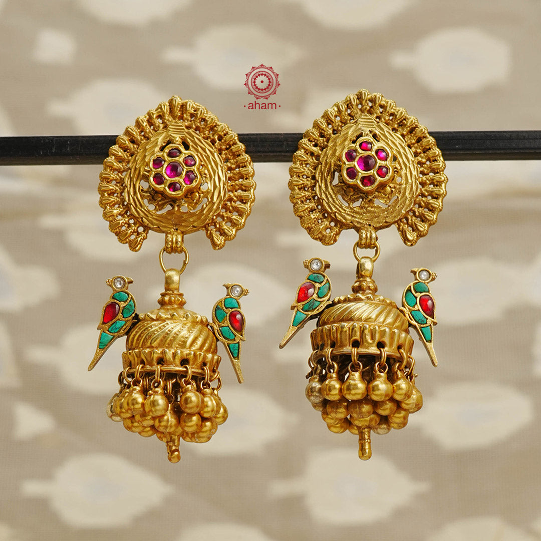 Elevate your style with our Peacock Gold Polish Silver Jhumkas. Crafted with stunning turquoise kundan birds highlights, these statement earrings are the perfect accessory to elevate any outfit. The gold polish adds a touch of elegance, making them a versatile match for most ensembles.