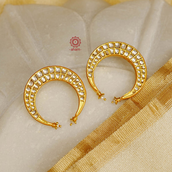 Add sparkle and shine to any outfit with our Crescent Moon Gold Polish Silver Earrings. Expertly crafted in 92.5 silver with kundan and dipped in luxurious gold, these glamorous half moon earrings are sure to make a statement. Elevate your style with this elegant and timeless accessory.