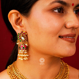 Introducing these Peacock Gold Polish Silver Jhumkie earrings - stunningly designed with a temple style inspired by ancient craftsmanship. Finely crafted with 92.5 sterling silver and a beautiful gold polish, they boast exquisite details that make them truly unique. The pearls add a gentle touch to the intricate design, making these earrings so light yet gorgeous.