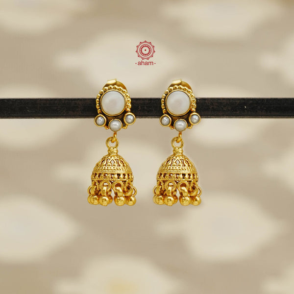 Accentuate your style with our Pearl Gold Polish Silver Earrings. These stunning jhumkies feature a delicate gold polish and are crafted from high-quality 92.5 silver. The intricate pearl detailing adds a touch of elegance to any ensemble. Elevate your look with these beautiful earrings.
