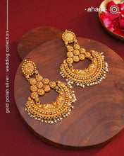 Statement gold polish chandbali earring with nakshi work. Handcrafted using traditional methods in 92.5 sterling silver with dangling cultured pearls. Pair these with your ethnic outfits this festive season to ace your look.