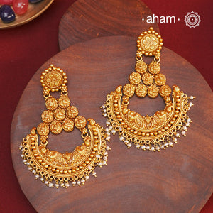 Statement gold polish chandbali earring with nakshi work. Handcrafted using traditional methods in 92.5 sterling silver with dangling cultured pearls. Pair these with your ethnic outfits this festive season to ace your look.