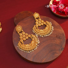 Statement gold polish chandbali earring with nakshi work. Handcrafted using traditional methods in 92.5 sterling silver with dangling cultured pearls. Pair these with your ethnic outfits this festive season to ace your look.