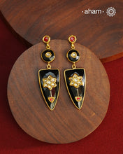 These Black Onyx Gold Polish Silver Earrings feature exquisite kundan inlay work, blending traditional craftsmanship with contemporary style. Perfectly suited for Indo-Western ensembles, they add a touch of elegance and sophistication to your look. Crafted with attention to detail, these earrings enhance your outfit with their rich black onyx contrast and subtle gold polish, making them a versatile accessory for special occasions.