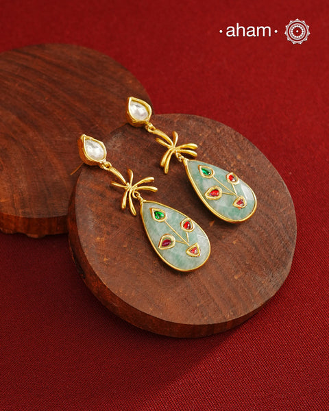 Gold Polish Silver Stone drop Earrings feature exquisite kundan inlay work, blending traditional craftsmanship with contemporary style. Perfectly suited for Indo-Western ensembles, they add a touch of elegance and sophistication to your look. Crafted with attention to detail, these earrings enhance your outfit making them a versatile accessory for special occasions.