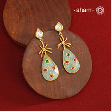 Gold Polish Silver Stone drop Earrings feature exquisite kundan inlay work, blending traditional craftsmanship with contemporary style. Perfectly suited for Indo-Western ensembles, they add a touch of elegance and sophistication to your look. Crafted with attention to detail, these earrings enhance your outfit making them a versatile accessory for special occasions.