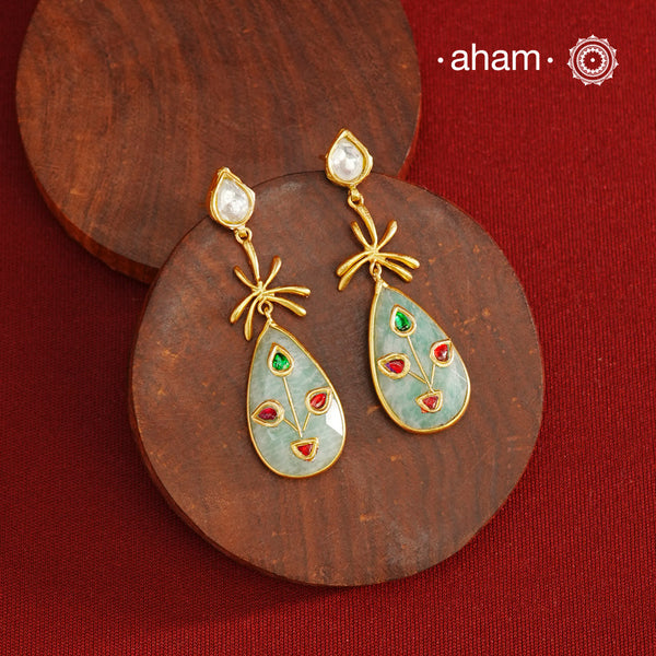 Gold Polish Silver Stone drop Earrings feature exquisite kundan inlay work, blending traditional craftsmanship with contemporary style. Perfectly suited for Indo-Western ensembles, they add a touch of elegance and sophistication to your look. Crafted with attention to detail, these earrings enhance your outfit making them a versatile accessory for special occasions.