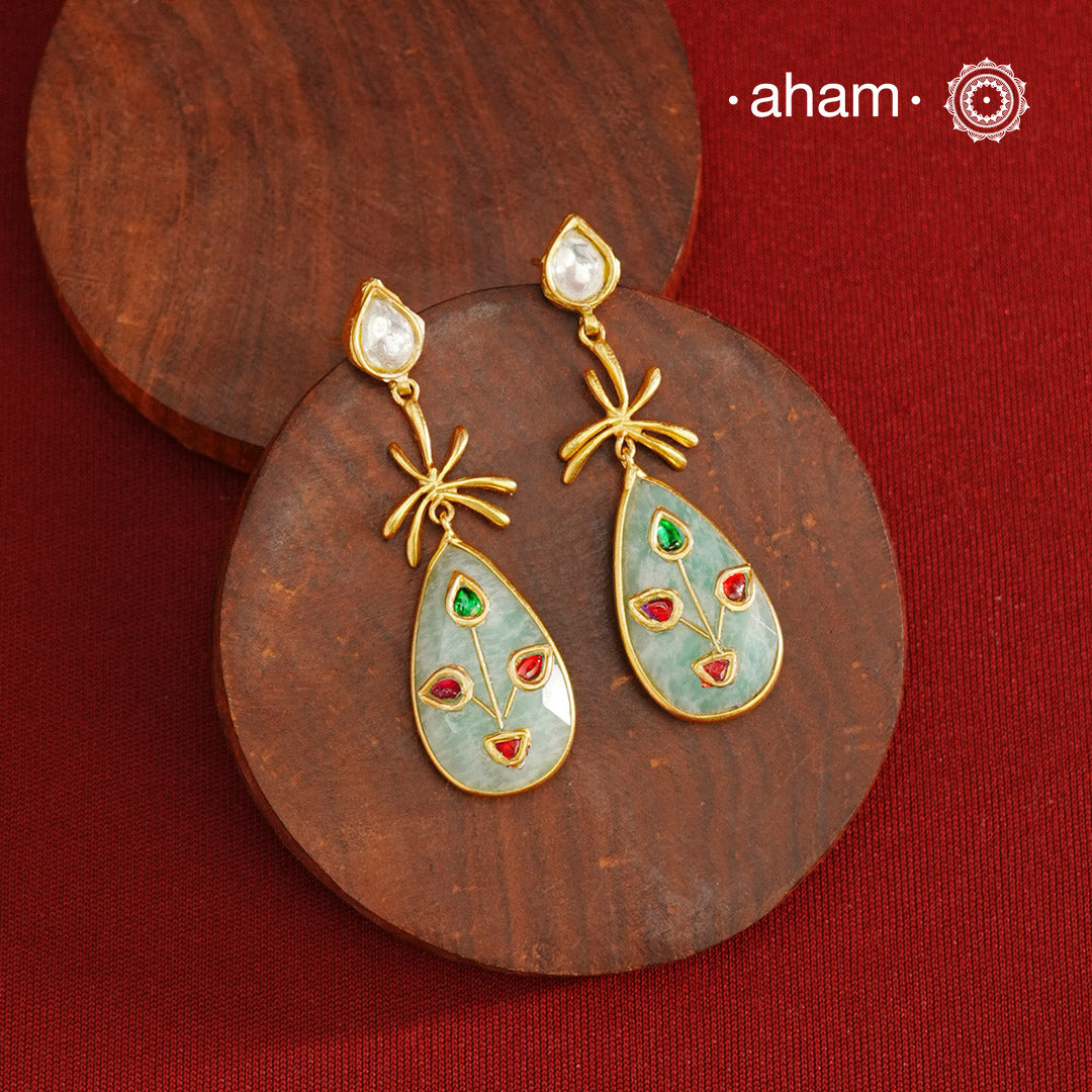 Gold Polish Silver Stone drop Earrings feature exquisite kundan inlay work, blending traditional craftsmanship with contemporary style. Perfectly suited for Indo-Western ensembles, they add a touch of elegance and sophistication to your look. Crafted with attention to detail, these earrings enhance your outfit making them a versatile accessory for special occasions.