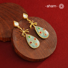 Gold Polish Silver Stone drop Earrings feature exquisite kundan inlay work, blending traditional craftsmanship with contemporary style. Perfectly suited for Indo-Western ensembles, they add a touch of elegance and sophistication to your look. Crafted with attention to detail, these earrings enhance your outfit making them a versatile accessory for special occasions.