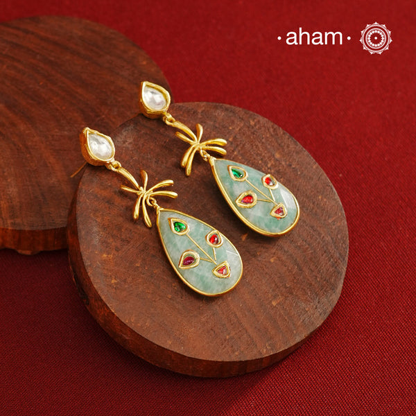 Gold Polish Silver Stone drop Earrings feature exquisite kundan inlay work, blending traditional craftsmanship with contemporary style. Perfectly suited for Indo-Western ensembles, they add a touch of elegance and sophistication to your look. Crafted with attention to detail, these earrings enhance your outfit making them a versatile accessory for special occasions.