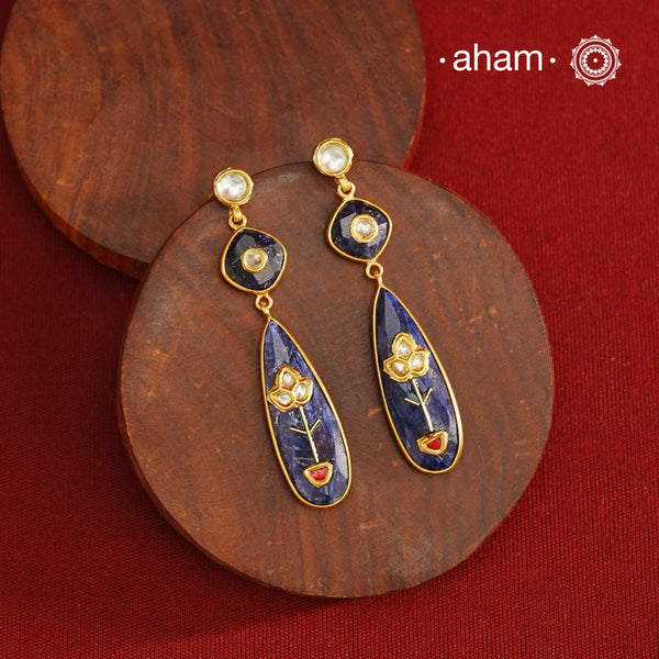 These Lapiz Gold Polish Silver Earrings feature exquisite kundan inlay work, blending traditional craftsmanship with contemporary style. Perfectly suited for Indo-Western ensembles, they add a touch of elegance and sophistication to your look. Crafted with attention to detail, these earrings enhance your outfit with their deep blue contrast and subtle gold polish, making them a versatile accessory for special occasions.