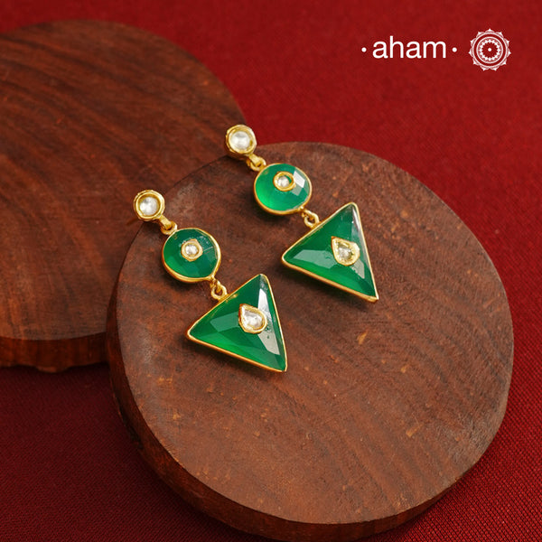These Green Onyx Gold Polish Silver Earrings feature exquisite kundan inlay work, blending traditional craftsmanship with contemporary style. Perfectly suited for Indo-Western ensembles, they add a touch of elegance and sophistication to your look. Crafted with attention to detail, these earrings enhance your outfit with their green onyx contrast and subtle gold polish, making them a versatile accessory for special occasions.