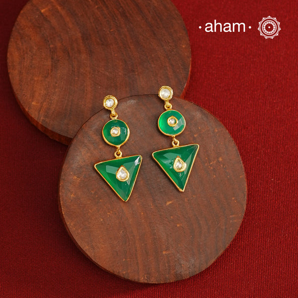 These Green Onyx Gold Polish Silver Earrings feature exquisite kundan inlay work, blending traditional craftsmanship with contemporary style. Perfectly suited for Indo-Western ensembles, they add a touch of elegance and sophistication to your look. Crafted with attention to detail, these earrings enhance your outfit with their green onyx contrast and subtle gold polish, making them a versatile accessory for special occasions.