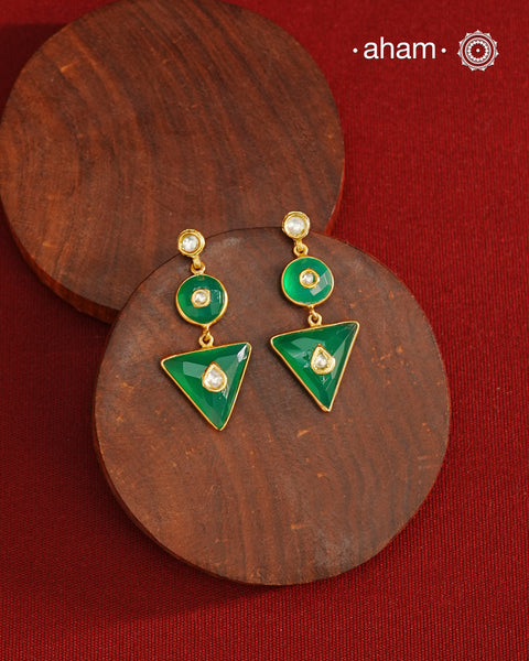 These Green Onyx Gold Polish Silver Earrings feature exquisite kundan inlay work, blending traditional craftsmanship with contemporary style. Perfectly suited for Indo-Western ensembles, they add a touch of elegance and sophistication to your look. Crafted with attention to detail, these earrings enhance your outfit with their green onyx contrast and subtle gold polish, making them a versatile accessory for special occasions.