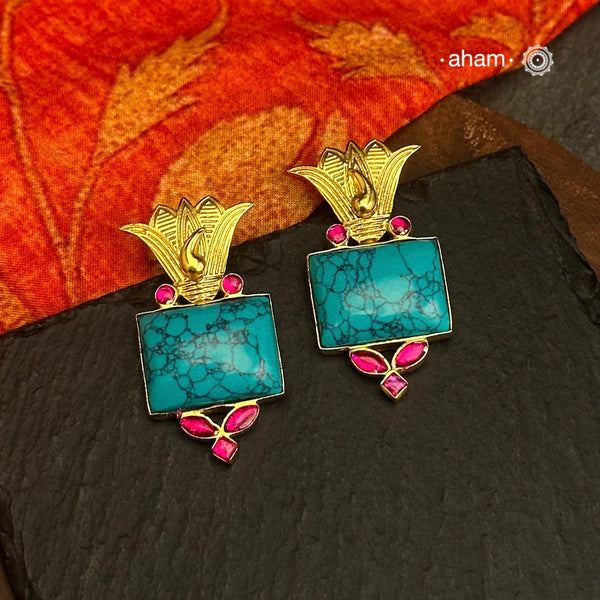 Gold Polish Silver Earrings. The earrings are handcrafted in 92.5 sterling silver with turquoise center and dipped in gold polish.Style this up with your favourite ethnic or fusion outfits to complete the look.