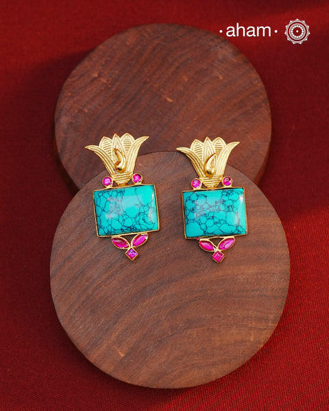 Gold Polish Silver Earrings. The earrings are handcrafted in 92.5 sterling silver with turquoise center and dipped in gold polish.&nbsp;Style this up with your favourite ethnic or fusion outfits to complete the look.