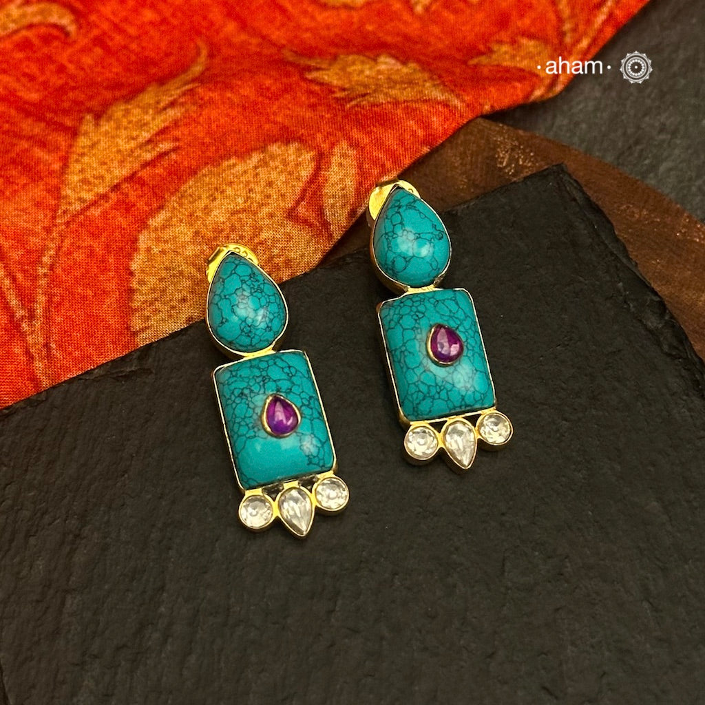 Gold Polish Silver Earrings. The earrings are handcrafted in 92.5 sterling silver with turquoise setting and gold polish. Style this up with your favourite ethnic outfits to complete the look.