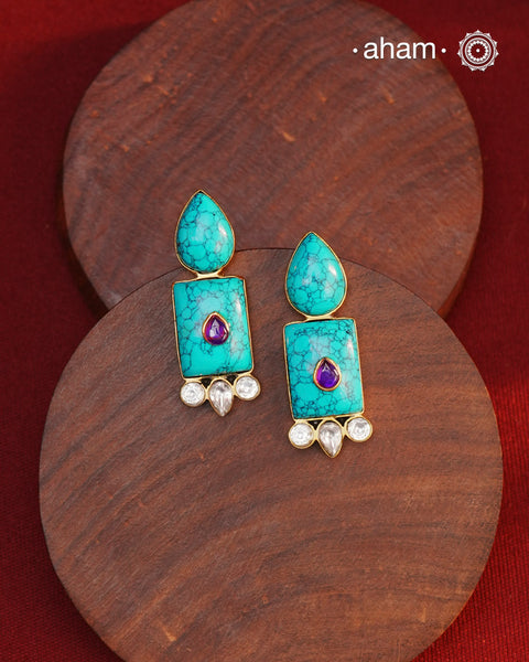 Gold Polish Silver Earrings. The earrings are handcrafted in 92.5 sterling silver with turquoise setting and gold polish. Style this up with your favourite ethnic outfits to complete the look.