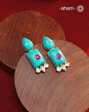 Gold Polish Silver Earrings. The earrings are handcrafted in 92.5 sterling silver with turquoise setting and gold polish. Style this up with your favourite ethnic outfits to complete the look.