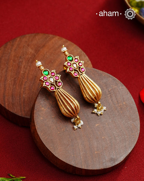 Add a touch of effortless glamour with our Gold Drop Silver Earrings. Crafted with silver and platted with gold polish, these earrings feature little kundan tops and a pearl drops,&nbsp; Perfect for any festive occasion