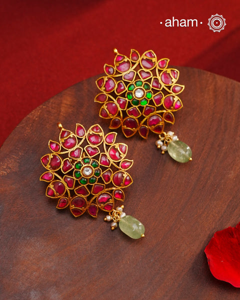 Expertly crafted with intricate kundan work, these Kundan Gold Polish Silver Earrings exude elegance and radiate sophistication. Made of 92.5 silver with a lustrous gold polish, they feature a timeless red and green color combination that pairs great with with most traditional Indian clothes. Elevate any outfit and make a statement with these exquisite earrings.
