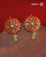 Expertly crafted with intricate kundan work, these Kundan Gold Polish Silver Earrings exude elegance and radiate sophistication. Made of 92.5 silver with a lustrous gold polish, they feature a timeless red and green color combination that pairs great with with most traditional Indian clothes. Elevate any outfit and make a statement with these exquisite earrings.